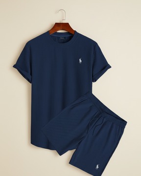 Navy ribbed lounge set by San Valier, including a t-shirt and shorts, displayed against a split background.