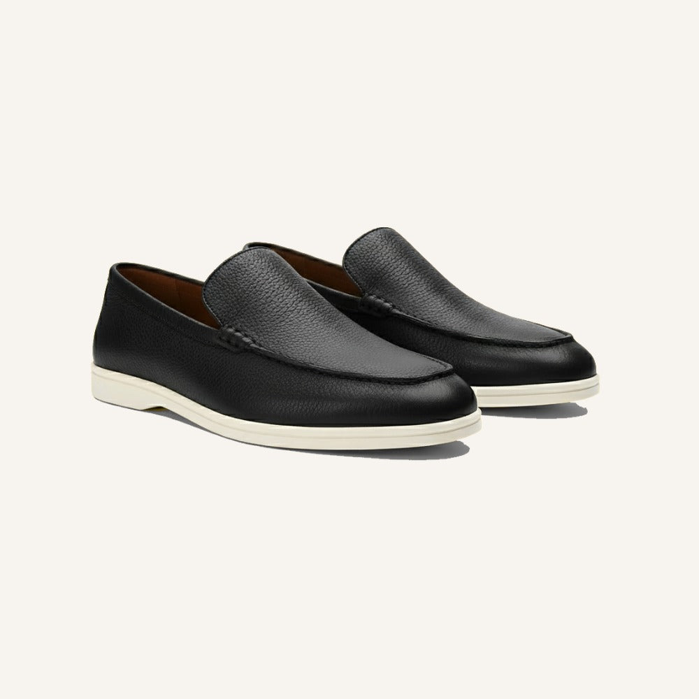 Black leather loafers by San Valier, featuring a pebbled texture and white rubber soles.