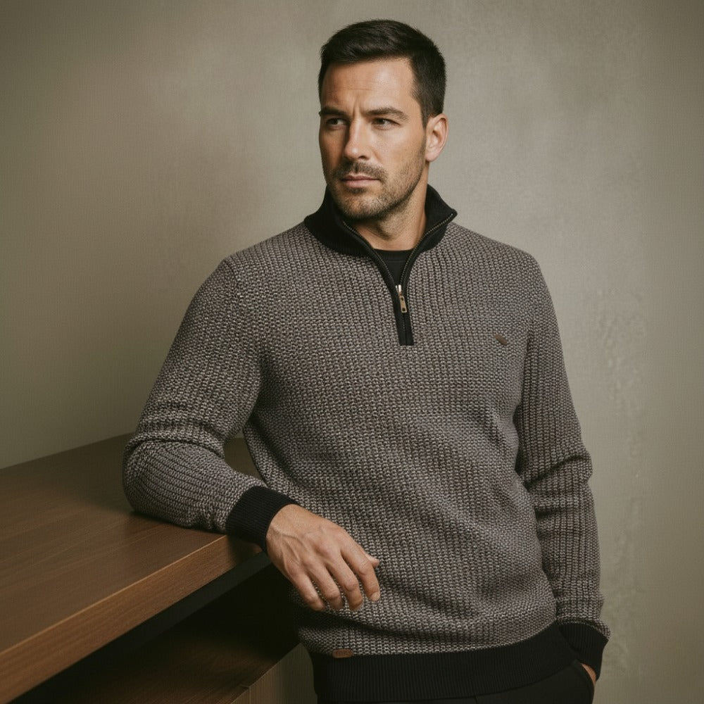 Men’s quarterzip knit sweater by San Valier, featuring a textured charcoal gray fabric with a partial zipper and banded cuffs.