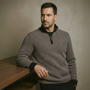 Men’s quarterzip knit sweater by San Valier, featuring a textured charcoal gray fabric with a partial zipper and banded cuffs.