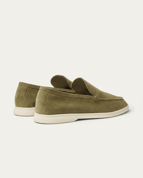 Olive green suede loafers by SanValier, with a moccasin-stitched toe and a light-colored sole.
